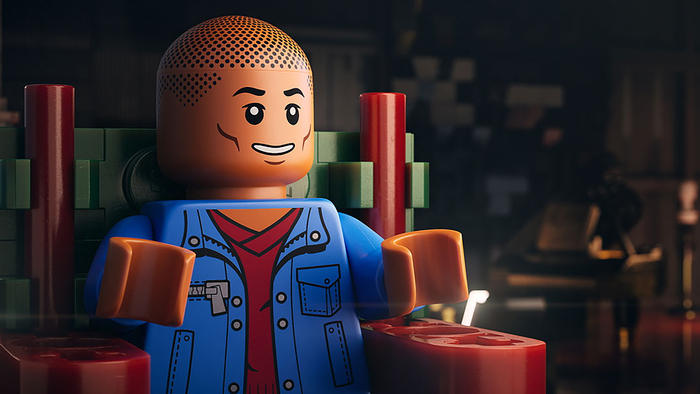 Un alter ego en Lego de Pharrell Williams assis sur une chaise, l'air confiant.