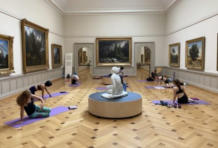 Groupe de personnes faisant du sport dans une salle du musée