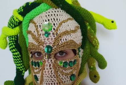 L'artiste textile Señora Serpiente porte un masque appelé "la méduse" avec des serpents réalisés en crochet.