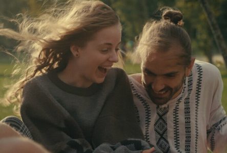 Un moment de complicité et de joie partagé entre deux personnes en plein air.