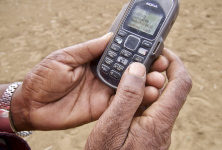 Deux mains qui tiennent un petit téléphone portable de la marque nokia.